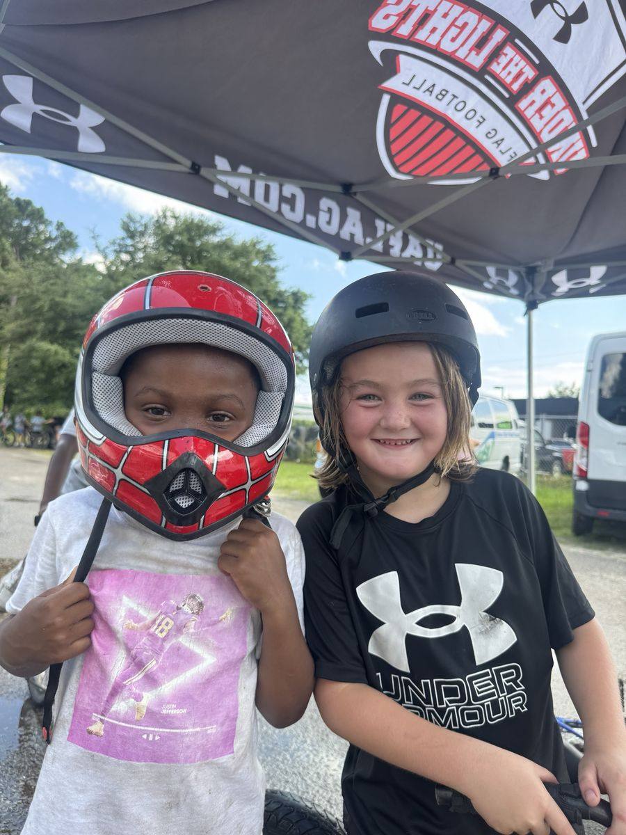 Two campers in bike helmets during Bike Week