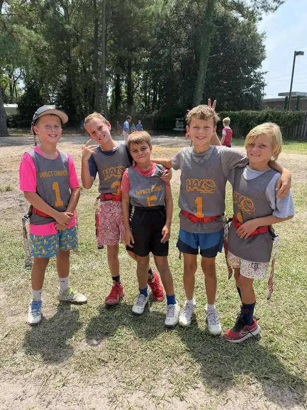Five FAST kids in gray pinnies on the field
