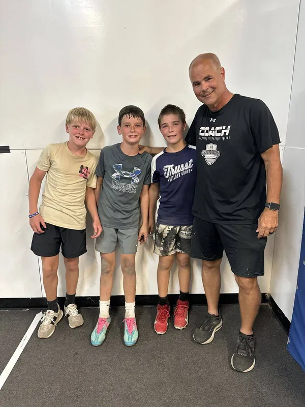 Coach Mike with three FAST kids indoors