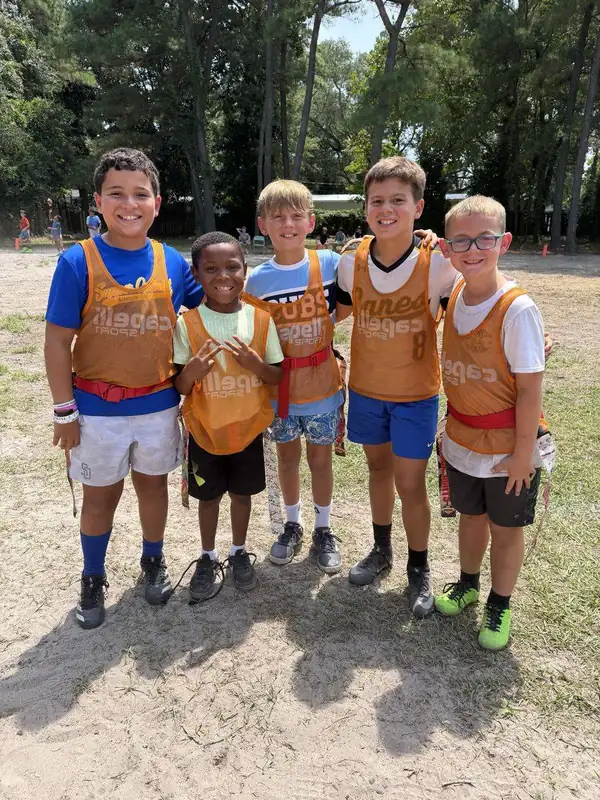 Five FAST kids in orange pinnies and flag belts