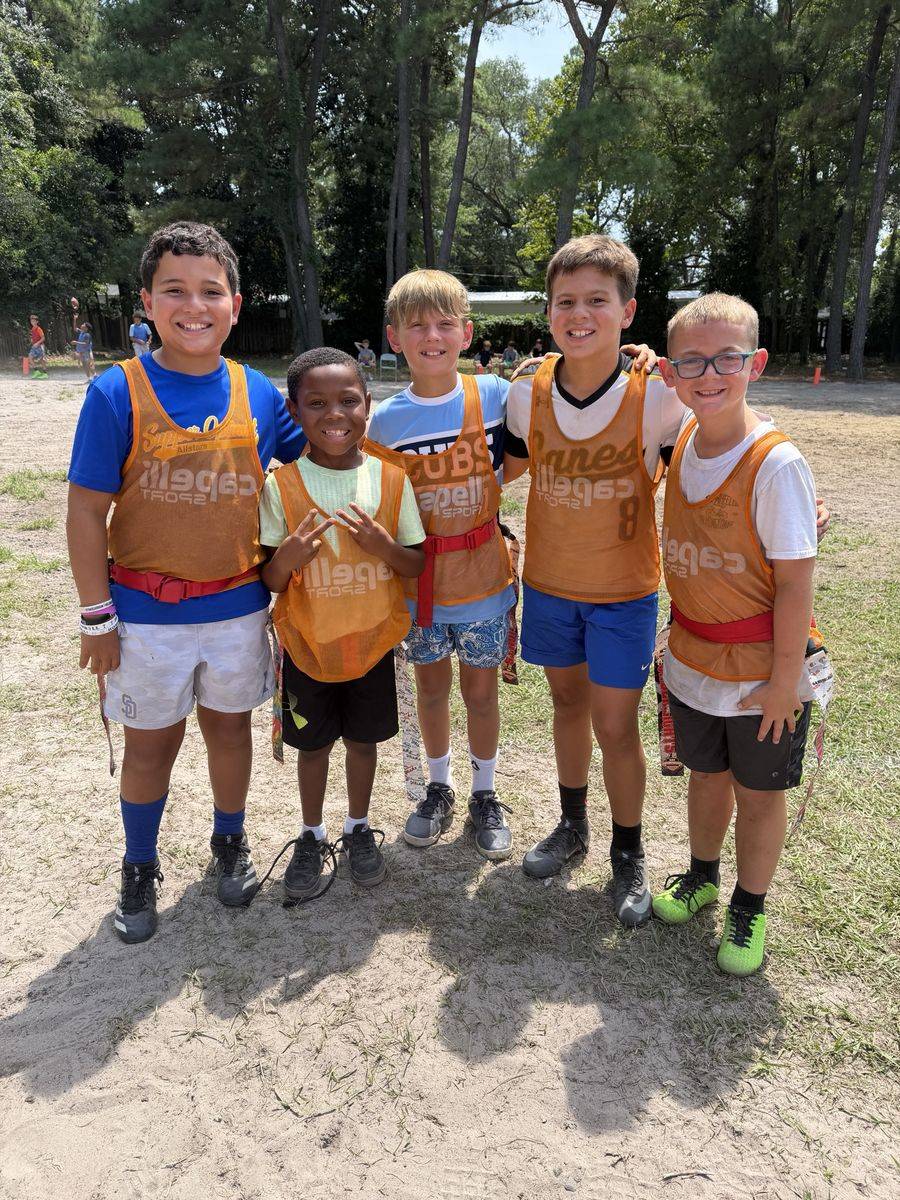 Five FAST kids in orange pinnies and flag belts